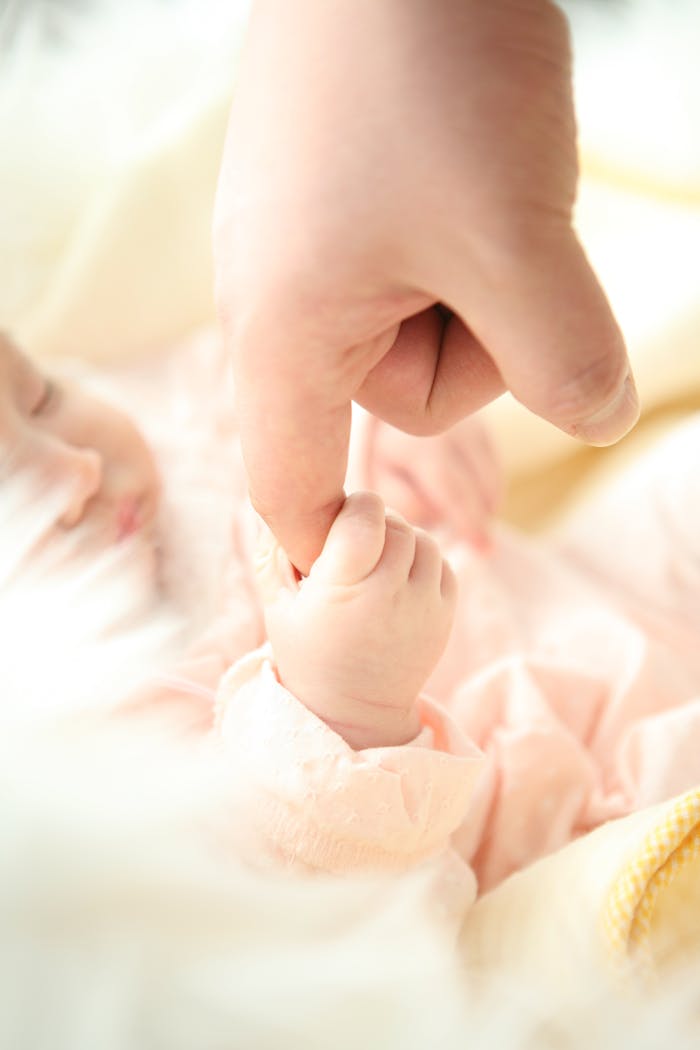 Mastering the First Impression: Your intriguing post title goes here Heartwarming close-up of a baby holding a parent's finger, symbolizing love and connection.